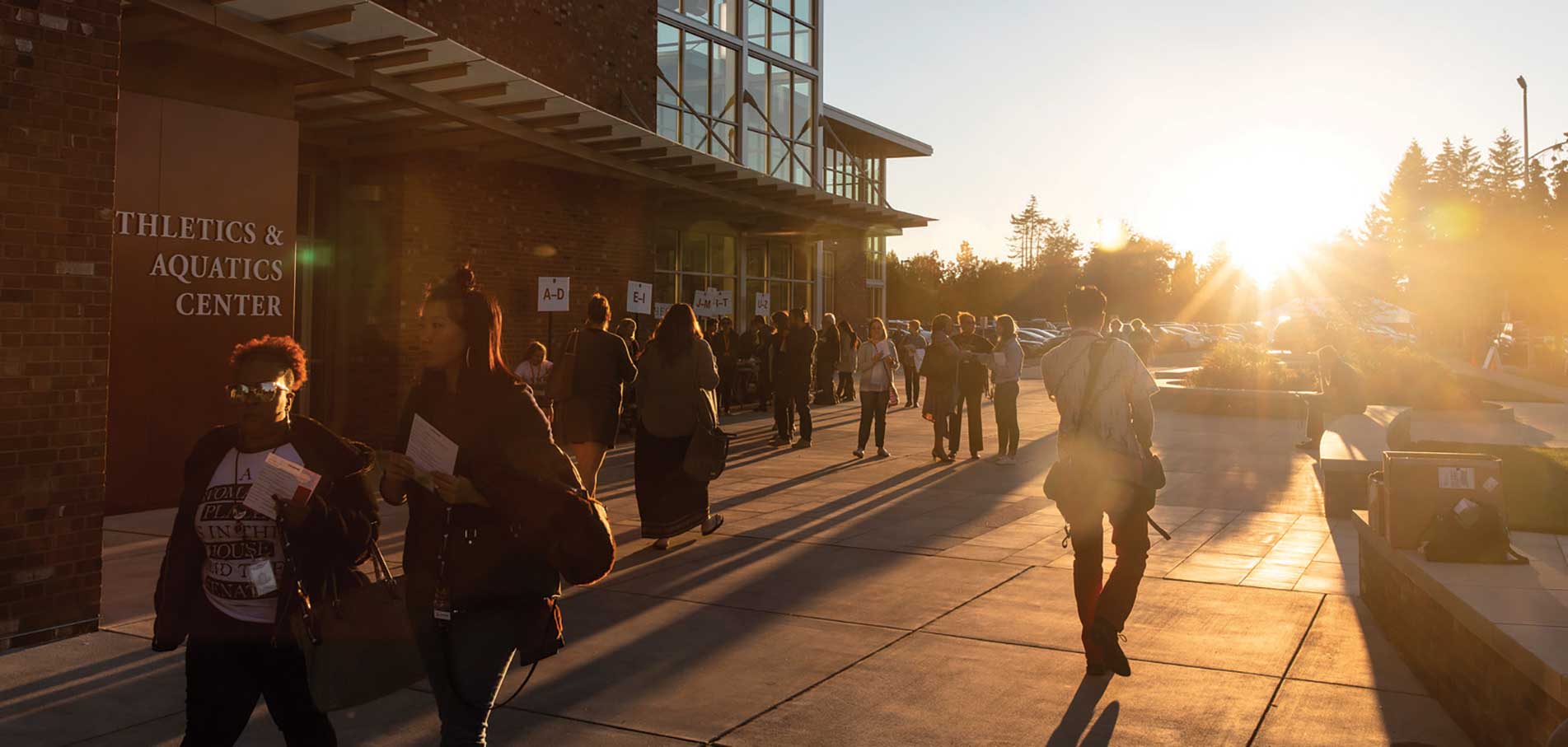 students walking on campus at sunset