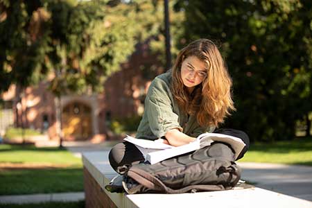 student sitting outside and studying